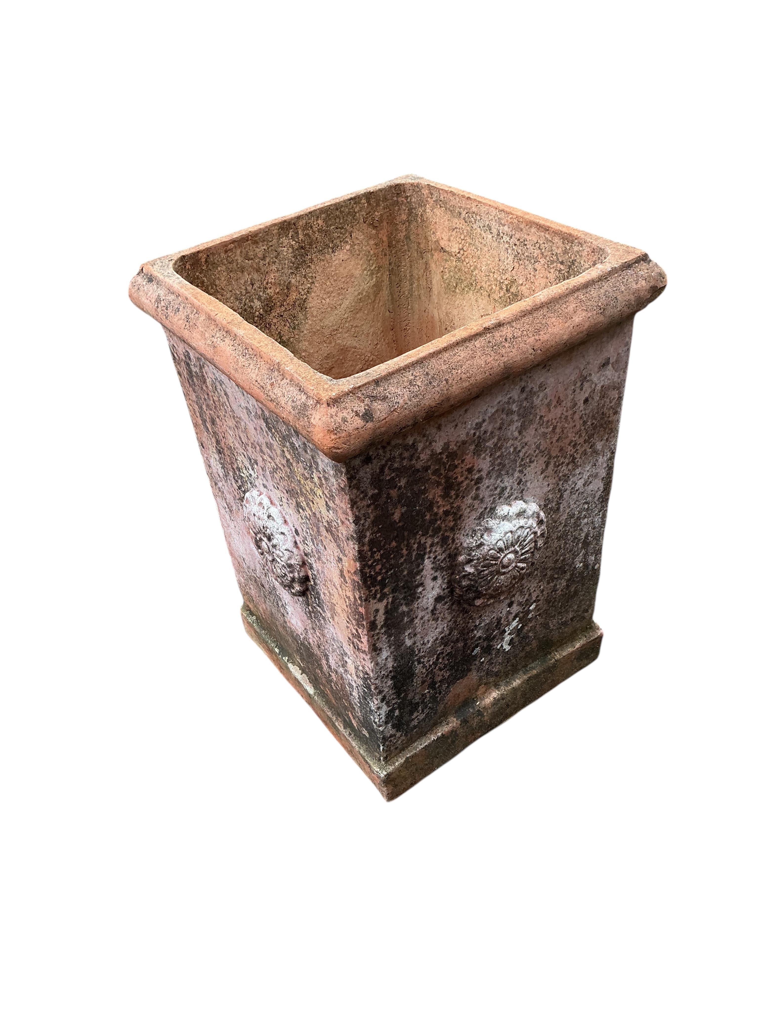 A large square terracotta garden planter, width 46cm, height 64cm
